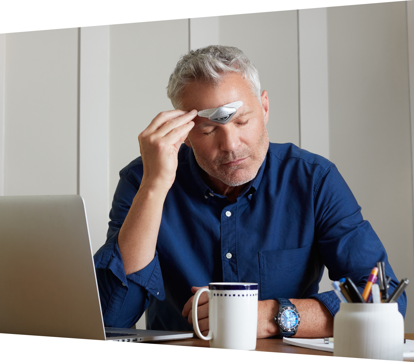 Woman laying down with her eyes closed using her Cefaly device to prevent and treat her migraines