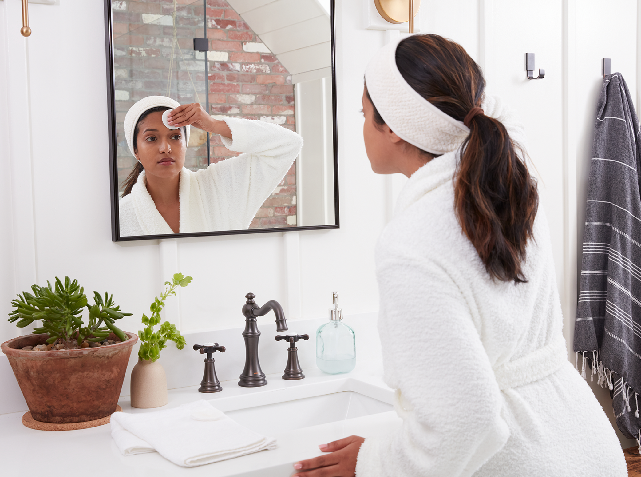 Step 1 illustration - woman cleaning her forehead