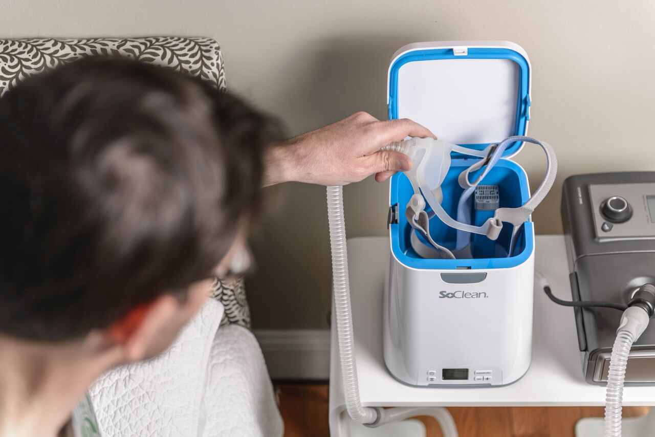 Man placing CPAP mask into SoClean 2
