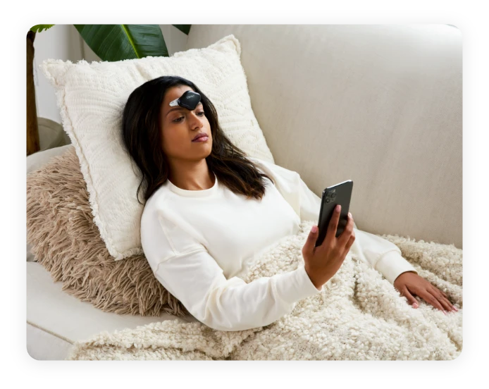 Woman on couch with CEFALY device