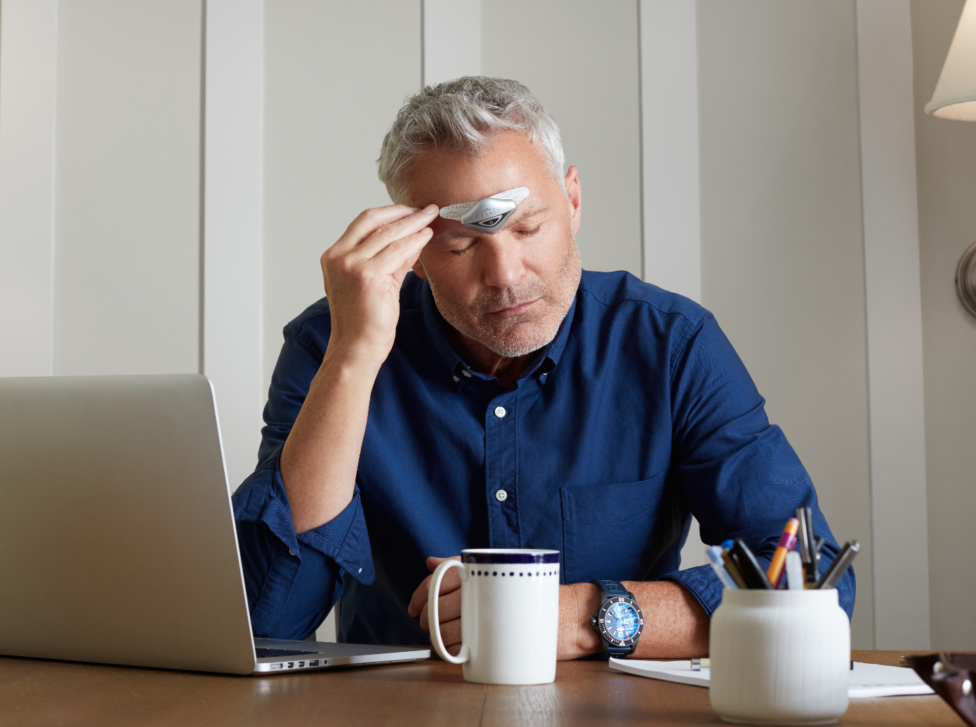 Man using Cefaly DUAL while relaxing